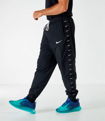 nike woven taping cuffed joggers in black