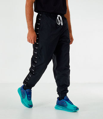 nike swoosh logo cuffed joggers in black